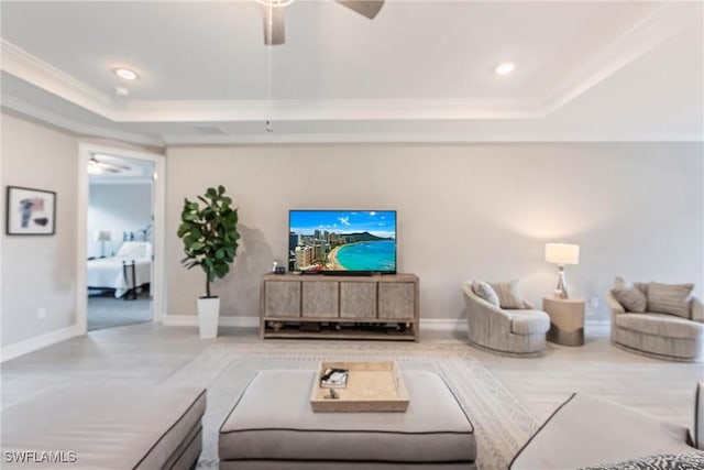 living room with crown molding, ceiling fan, and a raised ceiling