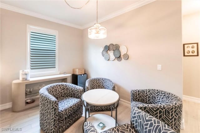 sitting room with crown molding and light wood-type flooring