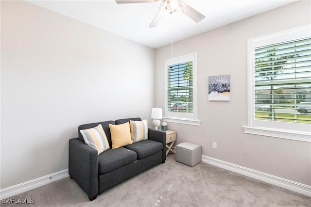 carpeted living room featuring ceiling fan