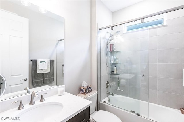 full bathroom featuring toilet, vanity, and shower / bath combination with glass door