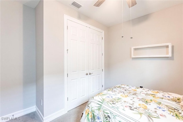 carpeted bedroom with a closet and ceiling fan