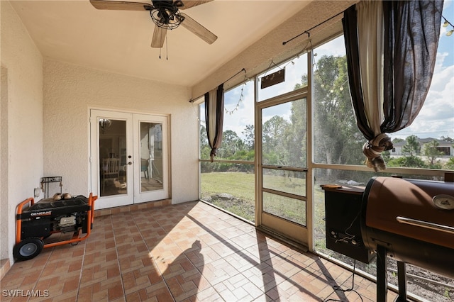 sunroom featuring french doors and ceiling fan