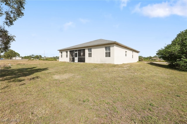 rear view of property with a lawn