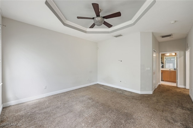 carpeted empty room with crown molding, ceiling fan, and a tray ceiling