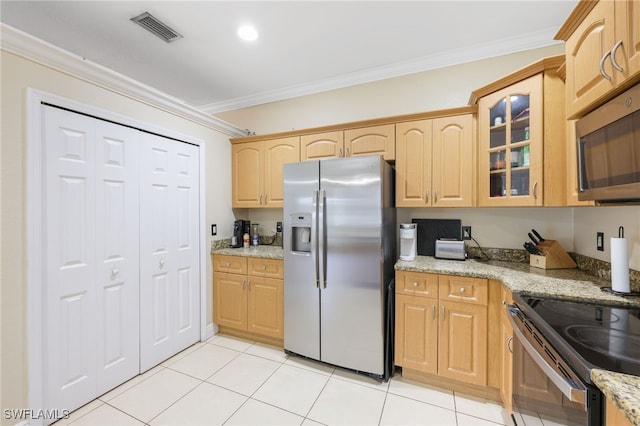 kitchen featuring crown molding, appliances with stainless steel finishes, and light stone counters