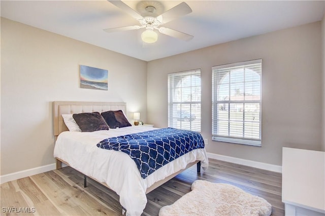 bedroom with hardwood / wood-style floors and ceiling fan