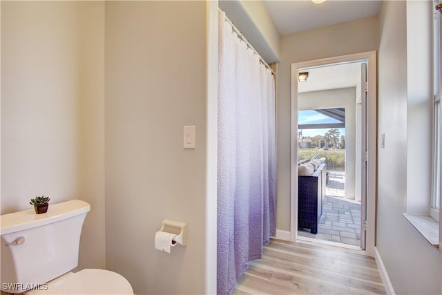 bathroom featuring toilet and hardwood / wood-style floors