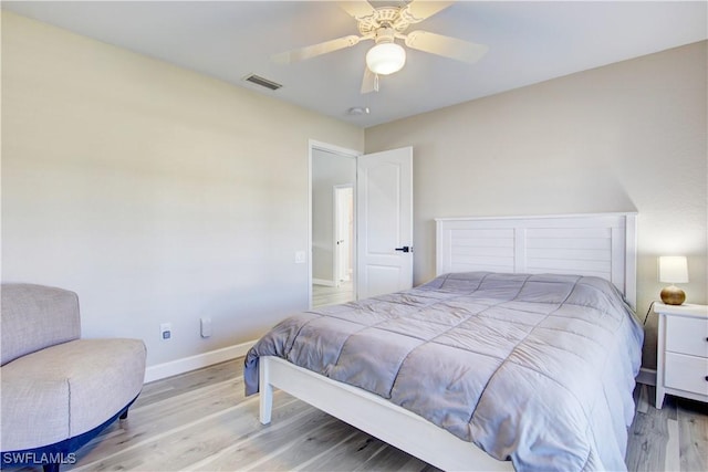 bedroom with ceiling fan and light hardwood / wood-style floors