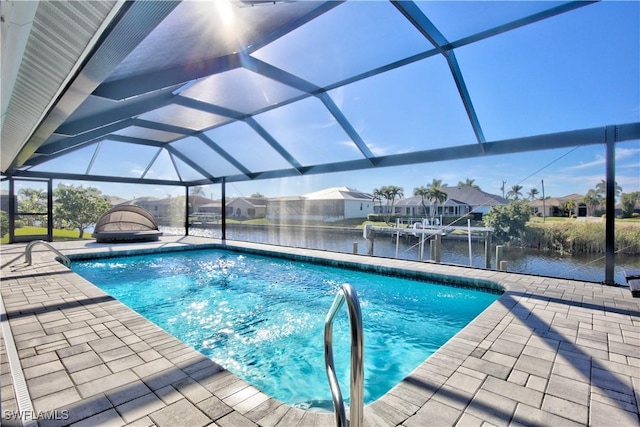 view of pool featuring a patio, a water view, and a lanai