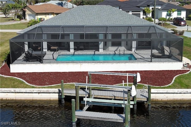 rear view of house with a patio, a water view, and glass enclosure