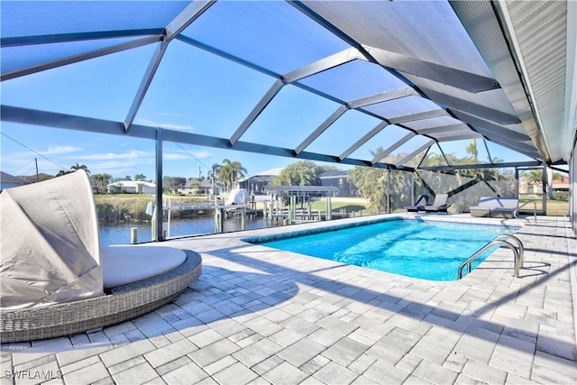 view of swimming pool featuring a water view, a lanai, and a patio area