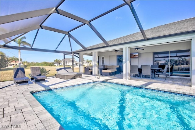 view of pool featuring a lanai, outdoor lounge area, a patio, and ceiling fan