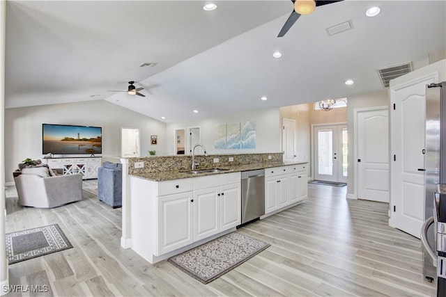 kitchen featuring dishwasher, sink, dark stone countertops, white cabinets, and ceiling fan