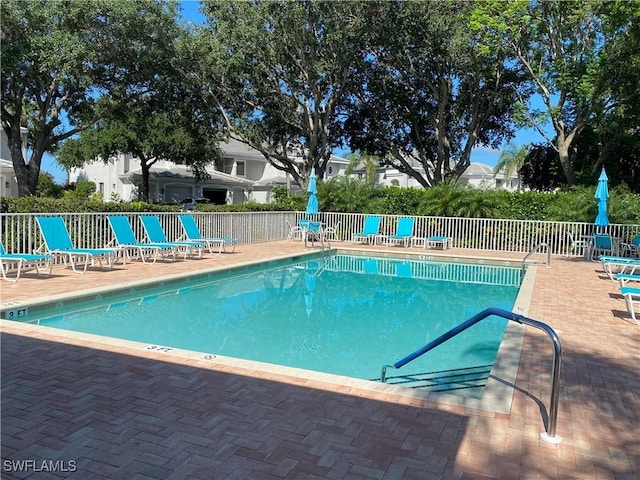 pool featuring a patio area and fence