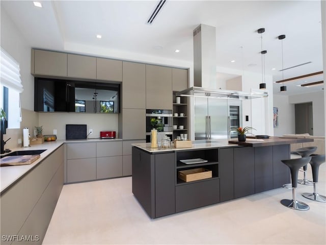 kitchen featuring appliances with stainless steel finishes, island range hood, and gray cabinetry