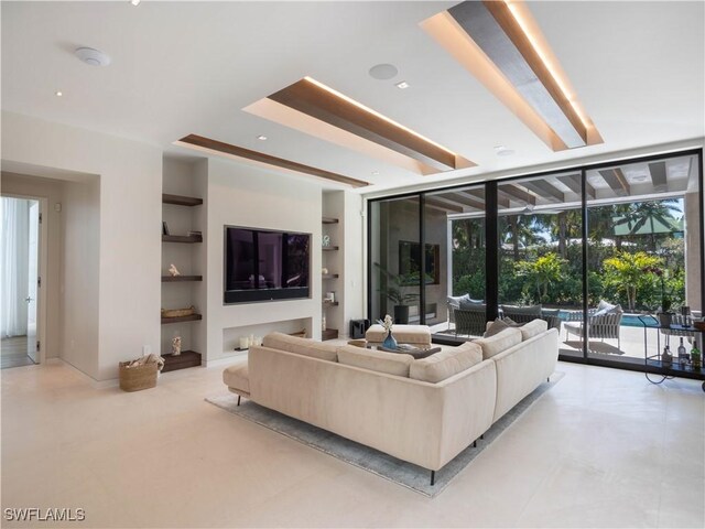 living area featuring a sunroom and built in shelves