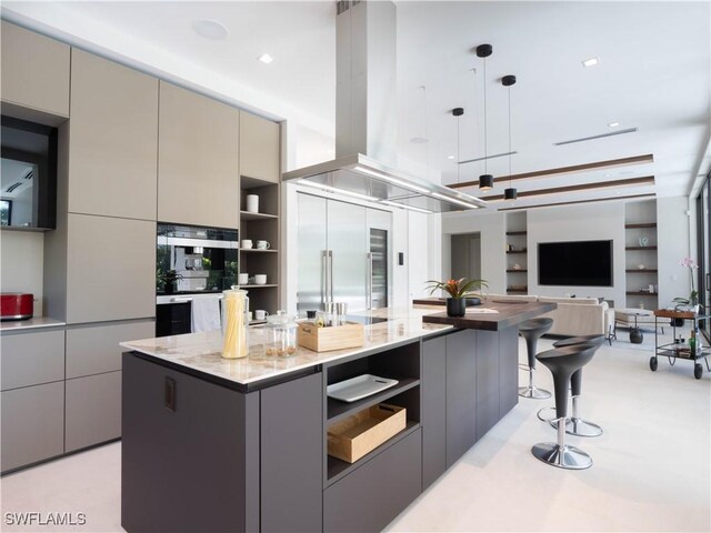 kitchen with gray cabinetry, island range hood, built in fridge, a kitchen island, and pendant lighting