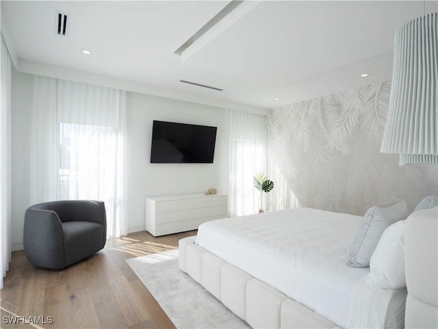 bedroom featuring recessed lighting, visible vents, wallpapered walls, and wood finished floors