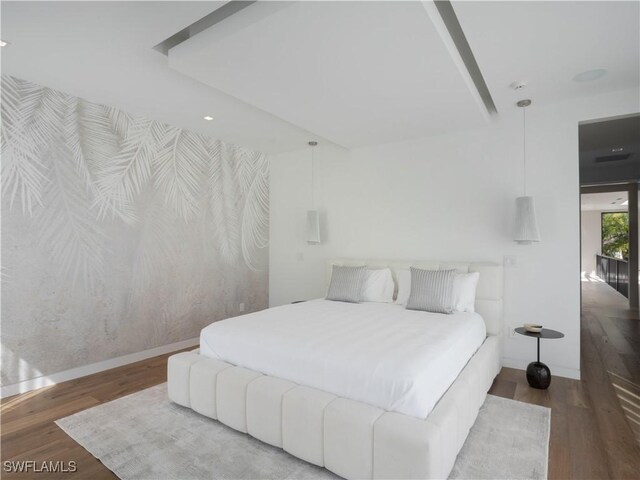 bedroom with dark hardwood / wood-style flooring