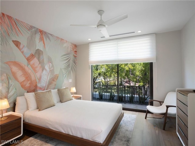 bedroom featuring wood-type flooring, access to outside, and ceiling fan