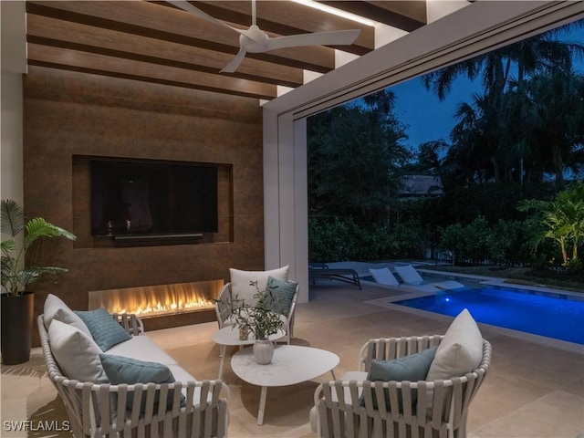 view of patio with ceiling fan and exterior fireplace