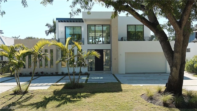 contemporary home with a garage and a front lawn