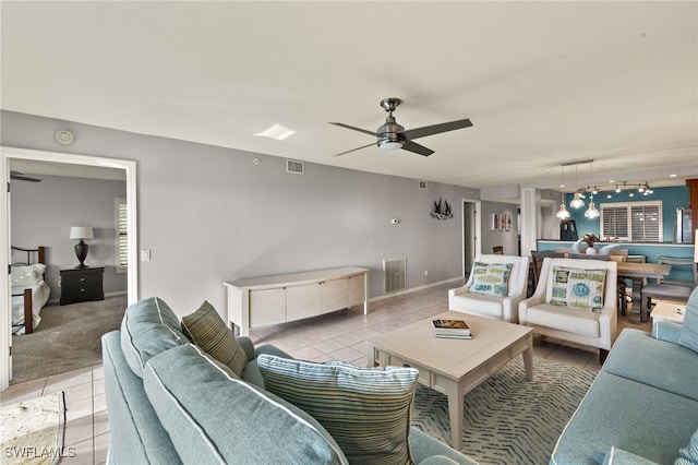 tiled living room with ceiling fan