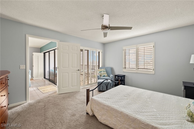 carpeted bedroom with ceiling fan and a textured ceiling