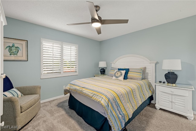 bedroom featuring light colored carpet and ceiling fan