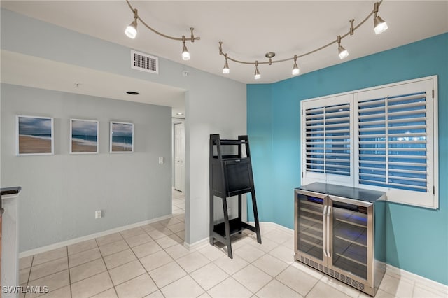 bar with light tile patterned flooring and wine cooler