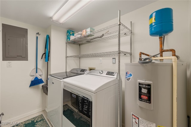 washroom featuring water heater, washing machine and clothes dryer, electric panel, and tile patterned floors