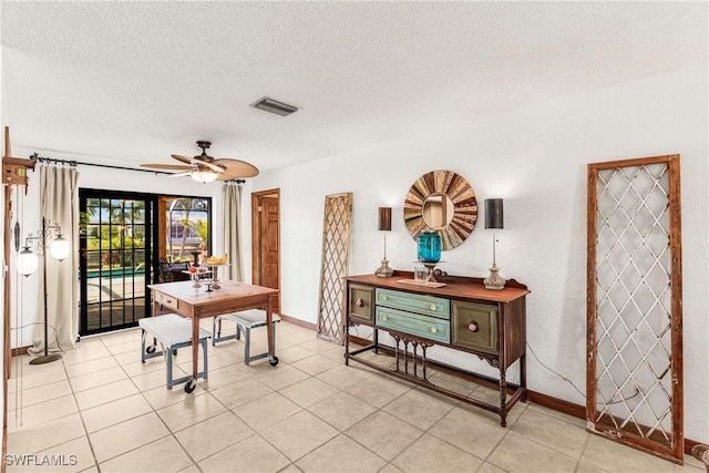 office area with visible vents, ceiling fan, a textured ceiling, and light tile patterned floors