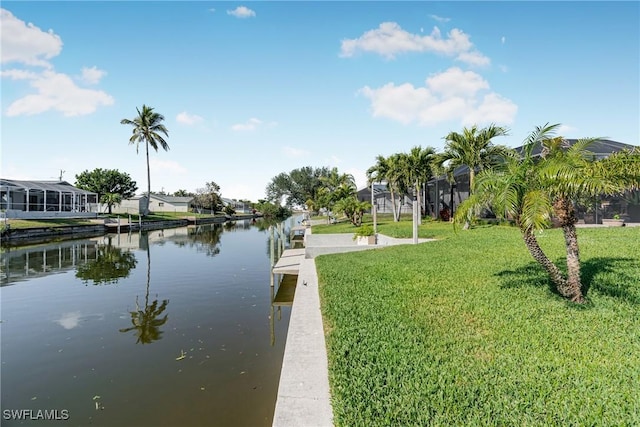 view of dock featuring a yard, a water view, and a residential view