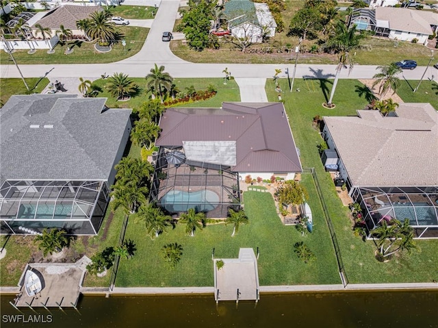 drone / aerial view with a residential view and a water view