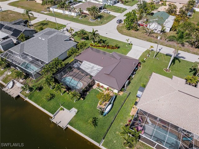 birds eye view of property featuring a water view and a residential view