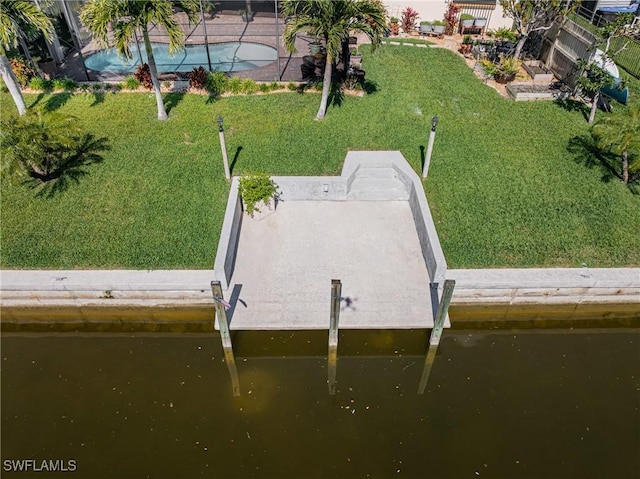 exterior space with a water view and a lawn