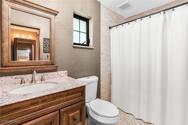 bathroom featuring a textured wall, toilet, visible vents, vanity, and a shower with curtain