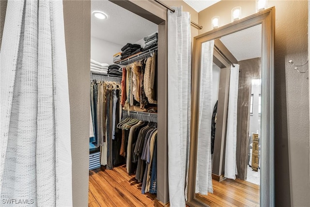 walk in closet featuring light hardwood / wood-style floors