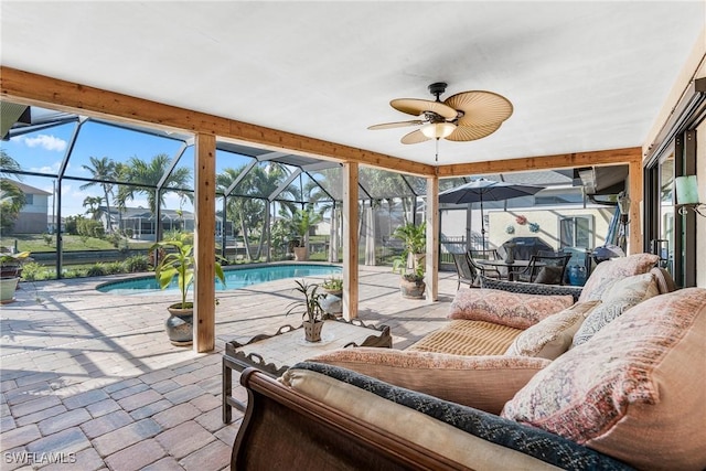 sunroom featuring ceiling fan and a pool