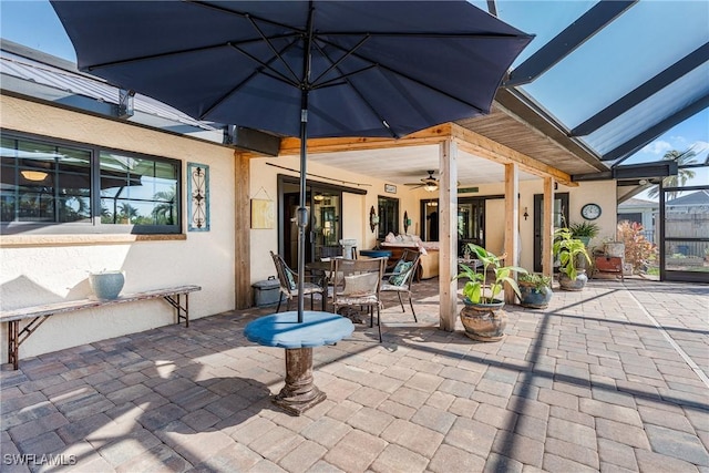 view of patio featuring a lanai and ceiling fan