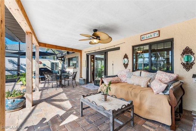 view of patio with an outdoor living space, a ceiling fan, and outdoor dining space