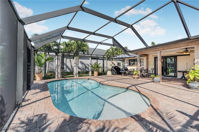 outdoor pool with a lanai and a patio area