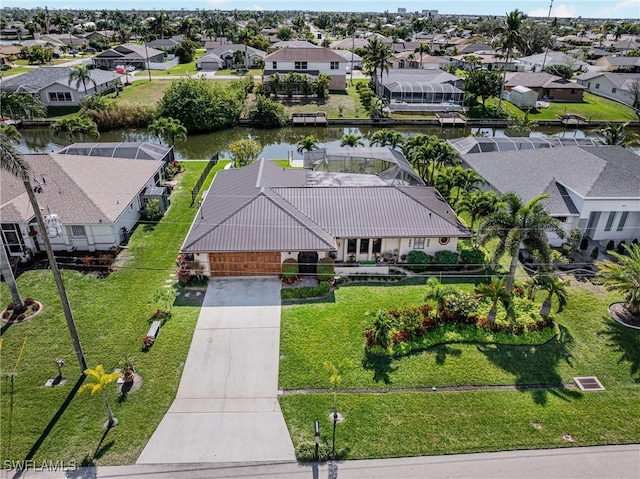 drone / aerial view featuring a water view and a residential view