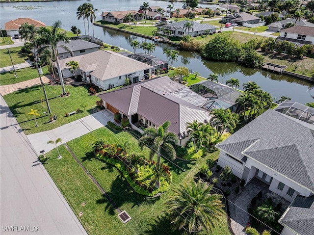 drone / aerial view featuring a water view and a residential view