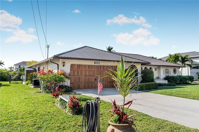 ranch-style house featuring a garage, central AC unit, and a front lawn