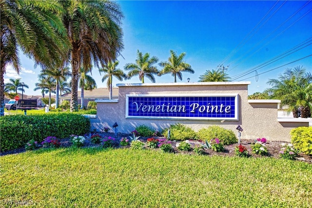 community / neighborhood sign featuring a lawn