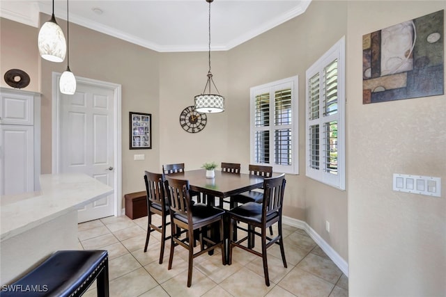 dining room with ornamental molding and light tile patterned floors