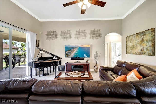 tiled living room with ceiling fan and ornamental molding