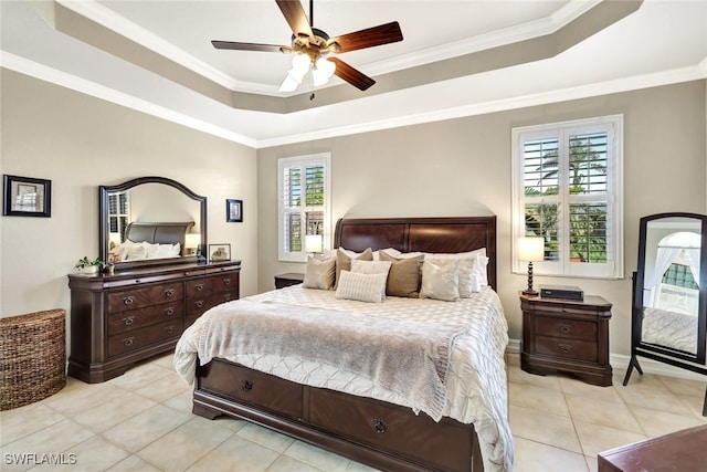 bedroom featuring crown molding, a tray ceiling, ceiling fan, and light tile patterned flooring