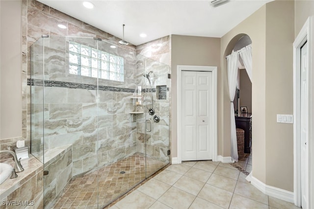 bathroom featuring tile patterned flooring and an enclosed shower